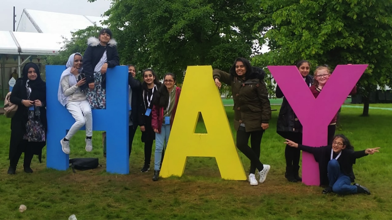 Bradford exchange pupils with HAY sign at Hay Festival