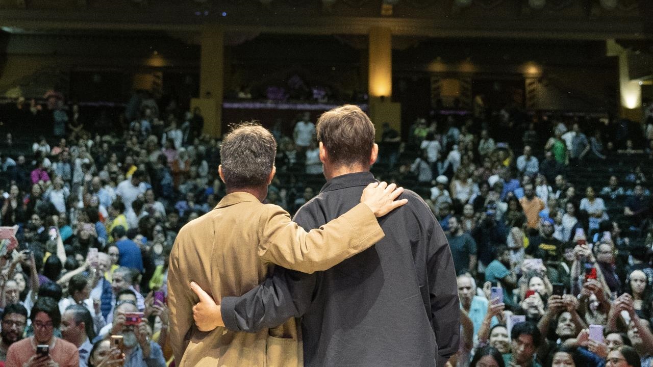speakers on stage in front of an audience