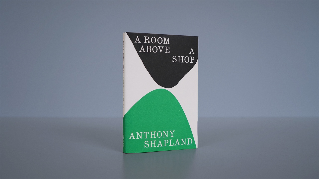 Two readers sitting on deck chairs outside at Hay Festival 2024