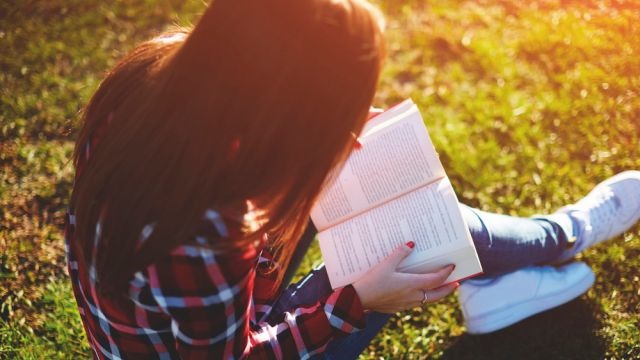 Girl reading on grass