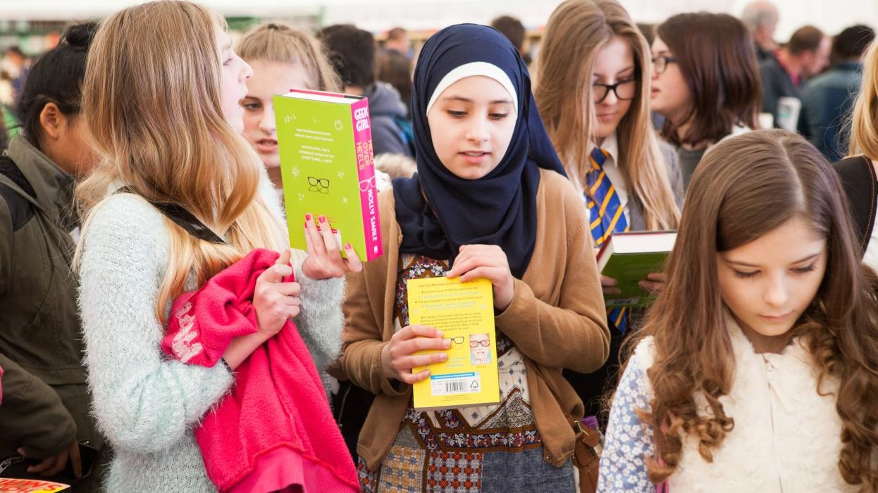 Girls choosing books in Hay Festival bookshop
