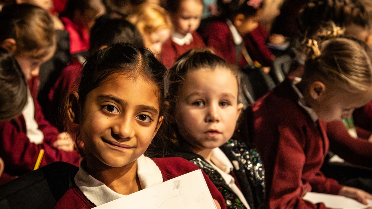 Primary school children waving